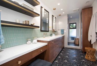 Modern San Diego area bathroom with geometric tile floor, green backsplash, wood vanity, and pendant lighting for a stylish spa-like feel